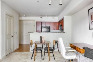 a kitchen and dining room with a table and chairs at Downtown Bellevue 1BR w WD Storage nr Shops SEA-321 in Bellevue +23 photos
