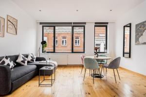 a living room with a couch and a table at Simone's Kitchen B&B in Antwerp