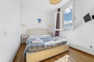 a bedroom with a bed with towels on it at Domus Karalis in Cagliari