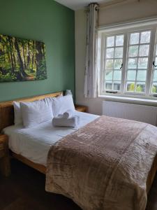 The Trusty Servant Inn في لِيندهيرست: غرفة نوم عليها سرير وفوط
