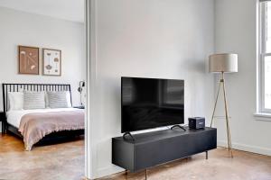 a bedroom with a bed and a tv in a room at Jersey City 1BR w Elevator WD quiet street NYC-729 in Jersey City