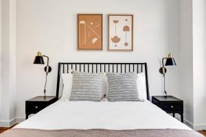 a bedroom with a white bed with two lamps at Jersey City 1BR w Elevator WD quiet street NYC-729 in Jersey City