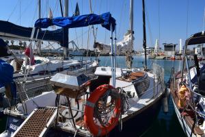 a boat is docked in a harbor with other boats at Velero en Puerto de Valencia - E&M Boats in Valencia