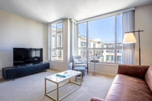 a living room with a couch and a tv at N Beach 1BR w Pool Fitness Center nr Muni SFO-233 in San Francisco