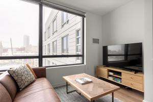 a living room with a couch and a large window at SoMa 1BR w WD Gym Roofdeck nr Muni BART SFO-273 in San Francisco