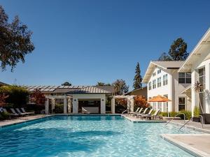a swimming pool in front of a house at Cupertino 1BR w Pool Gym AC nr shops SFO-371 in Cupertino