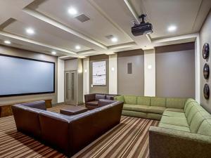 a large living room with couches and a large screen at Cupertino 1BR w Pool Gym AC nr shops SFO-371 in Cupertino