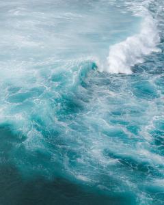 a wave in the ocean with a puff of smoke at The Patio at Monaco Tower in Lagundi