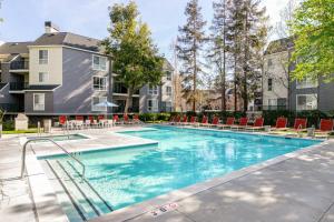 a swimming pool with chairs and a building at Santa Clara 2BR w Parking Gym nr Groceries SFO-446 in Santa Clara