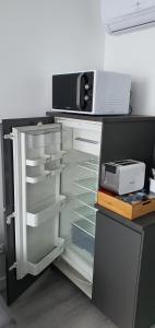 - otwartą lodówkę z kuchenką mikrofalową w obiekcie La Marion w mieście Saint-Jean-de-Losne