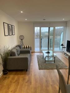 a living room with a couch and a table at Stunning 2 bed/2 bath Apartment in Warlingham