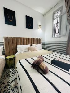 Postel nebo postele na pokoji v ubytování Riad Allal