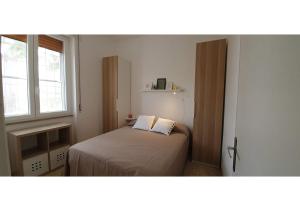 a small bedroom with a bed and a window at Villa Marisole in Torre Canne
