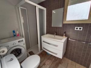 a bathroom with a washing machine and a sink at Jescamar 2 in Salou +18 photos