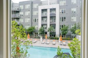 a view of a pool with chairs and a building at Milpitas 1BR w Pool Gym WD nr BART SFO-747 in Milpitas