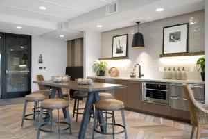 a kitchen with a table and bar stools at Redwood City 1BR w Gym WD nr Caltrain SFO-918 in Redwood City