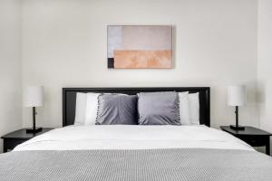 a bedroom with a large bed with two lamps at San Mateo 1BR w Gym Roof WD nr Caltrain SFO-1044 in San Mateo