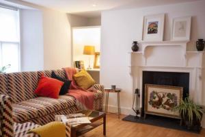 a living room with a couch and a fireplace at The Historical Harcourt Suites in Dublin