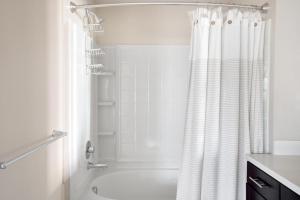 a bathroom with a shower and a white shower curtain at Burlingame 1BR w gym wd rooftop nr Caltrain SFO-1056 in Burlingame +31 photos