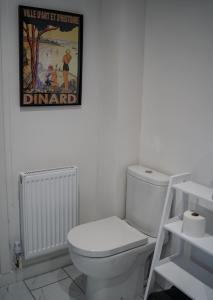 a bathroom with a toilet and a picture on the wall at The Red House- 3 Parking Spaces Walking Distance to City Centre and Cardiff Bay 3 dbl bedrooms in Cardiff