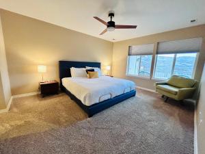 a bedroom with a bed and a chair and a ceiling fan at Mountain View Memories Gorgeous Views! 2 Story Pristine Condo Close to Foothills, Trails, Table Rock, Greenbelt, Bown Crossing and Barber Park in SE Boise in Boise