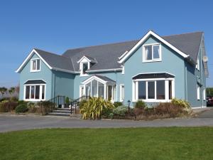 a blue house with a black roof at The Lighthouse in Dingle