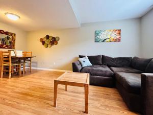 a living room with a couch and a table at Luxe on Penn Family Friendly, Toddler amenities, baby proof with baby gate, toys, bath toys, cups and plates, Separate Workstation with Desk and Monitor, located in desirable SE Boise next to the Greenbelt and Boise River in Boise