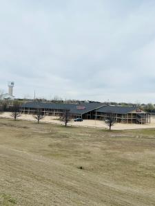 a large building with a parking lot in front of it at Cattle country lodge in Stroud