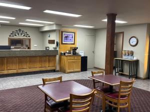 a waiting room with two tables and a counter at Cattle country lodge in Stroud