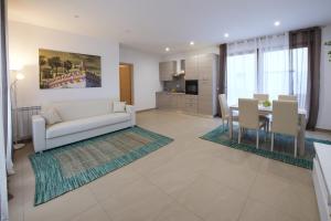 a living room with a couch and a table at Residence Rapisardi by RECEPTIO in Catania