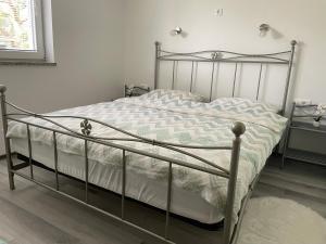 a bed with a metal frame in a bedroom at Green Oasis Garden in Šenčur