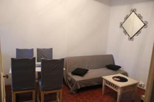 a room with a couch and a table and chairs at Appartement entier 40m2 in Les Arcs sur Argens
