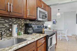 a kitchen with a sink and a counter top at Hoʻomaha 1 bedroom Suite + 1 Free Parking in Honolulu