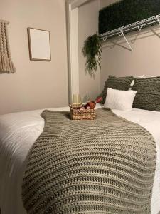 a bed with a basket with wine glasses on it at Jack London square stylish luxury 1BD apartment in Oakland