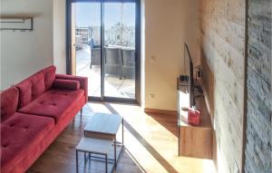 - un salon avec un canapé rouge et une table dans l'établissement Amazing Home In Saint-pierre-dalbigny With Kitchen, à Juvigny