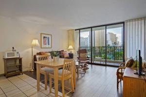 a living room with a dining table and a living room at Rec Deck Suite, 1 Bed Condo + Free Parking in Honolulu