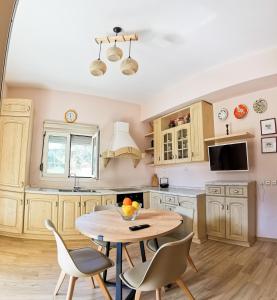 a kitchen with a table and chairs in a room at Seaside Serenity Kefalos in Kefalos