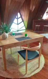 a wooden table with a chair in a room at Riverview Mid Century Modern Church in Innisfail