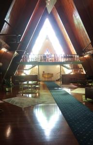 a large room with a roof with a table and chairs at Riverview Mid Century Modern Church in Innisfail