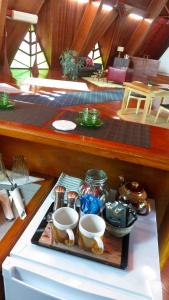 a tray with two cups on a table in a boat at Riverview Mid Century Modern Church in Innisfail