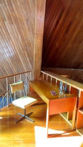 a room with a wooden table and a chair at Riverview Mid Century Modern Church in Innisfail