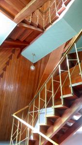 a metal staircase in a room with wooden ceilings at Riverview Mid Century Modern Church in Innisfail