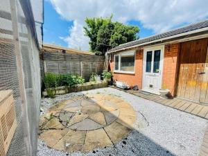 a backyard with a teddy bear painted on the ground at Spacious 5 Bedroom house with free parking by Hostaguest in Luton