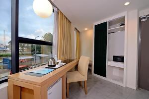 a kitchen with a desk and a large window at Oceania Hotel in Kota Kinabalu
