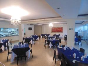 a dining room with blue tables and chairs at Samiria Jungle Hotel in Iquitos