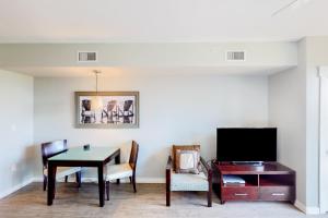a living room with a table and a tv at Elation #5316 in Destin