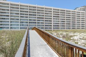 a wooden boardwalk leading to a large building at Navarre Beach Regency 805 in Navarre