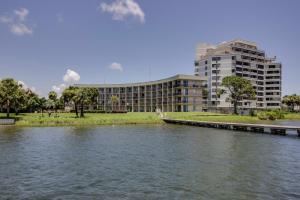 a building next to a river in front of a building at Pirates Bay A410 in Fort Walton Beach