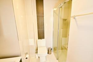 a bathroom with a toilet and a glass shower at Kings Cross Inn Hotel in London