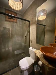 a bathroom with a toilet and a sink at Vila do Alto - Beach Homes in Itarema